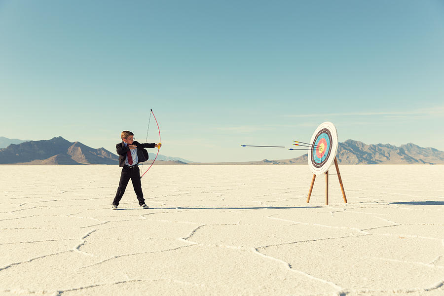 Young Boy Businessman Shoots Arrows at Target #1 Photograph by RichVintage