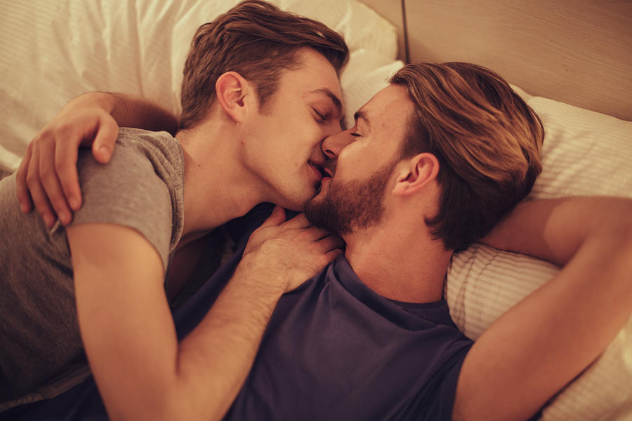 Young gay couple in bedroom. #1 Photograph by Svetikd