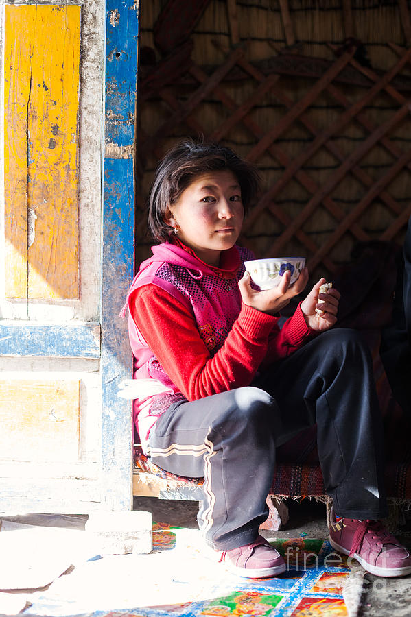 Young kyrgyz girl drinking tea inside a yurt China #1 Photograph by Matteo Colombo