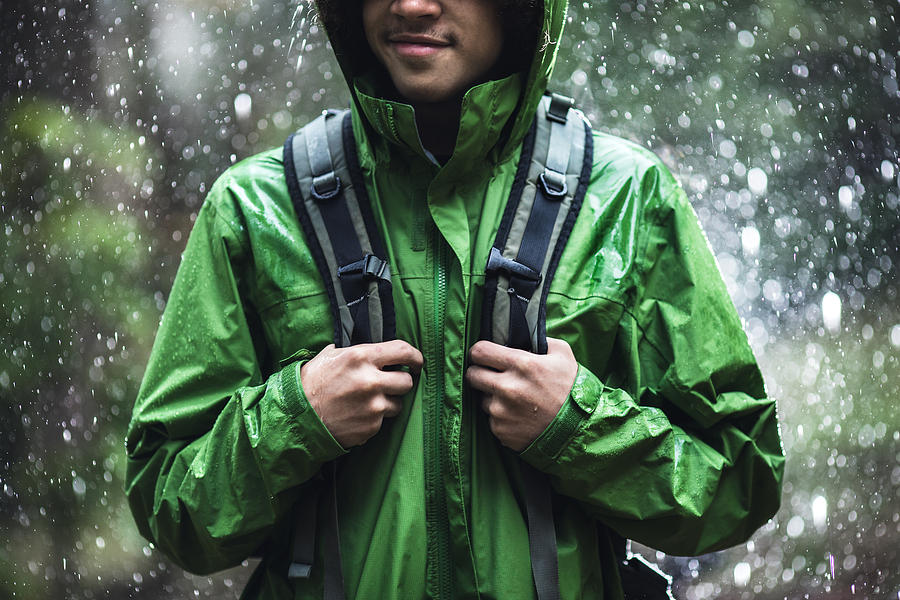 Young Man Hiking in Rain with Waterproof Jacket #1 Photograph by RyanJLane