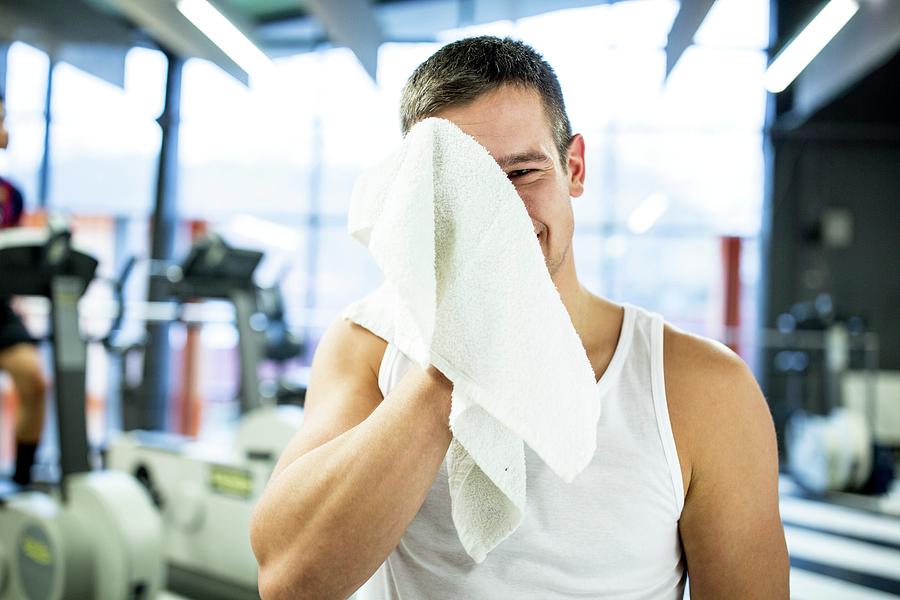 Young Man Wiping His Sweat With Towel #1 Photograph by Science Photo Library