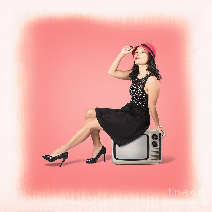 charming retro woman sitting on vintage suitcase and tv set while