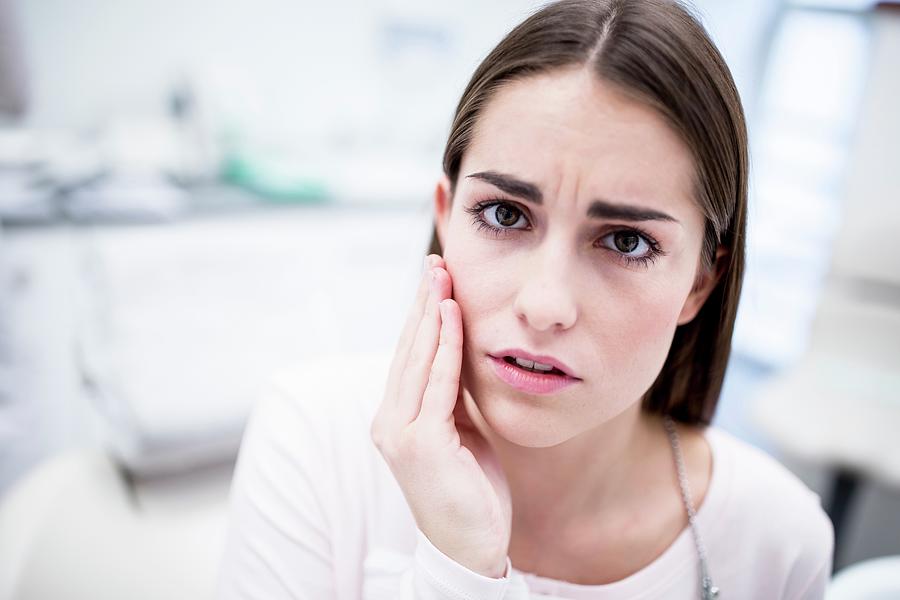 She has toothache she. Young woman suffering from toothache.