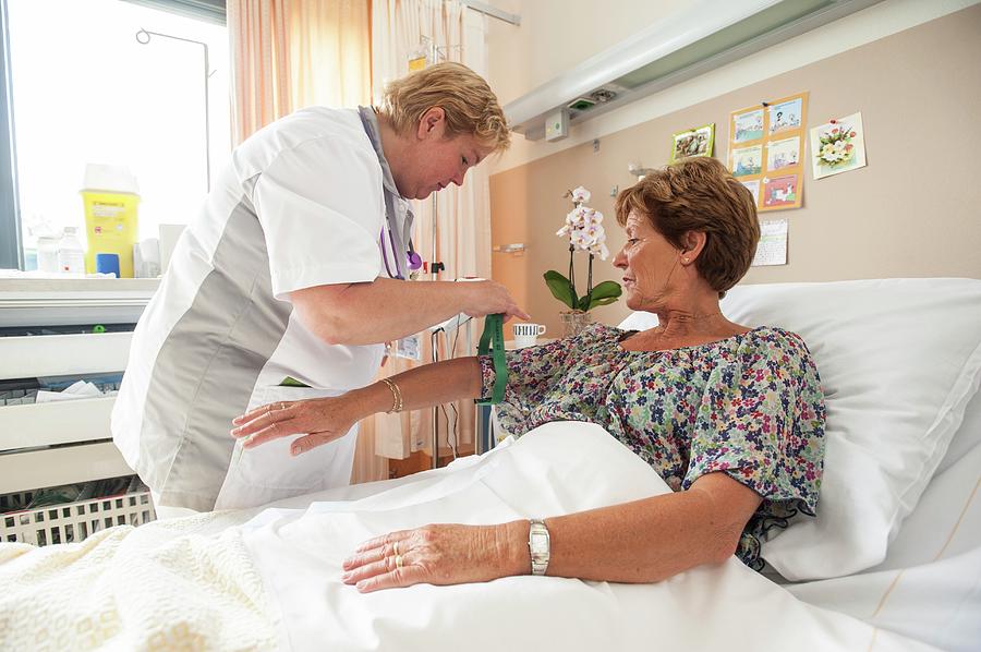 Nurse Preparing A Patient For An Iv Line Photograph by Arno Massee ...