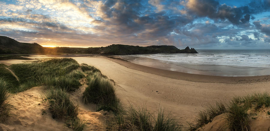 Stunning sunrise landscape over Three Cliffs Bay in Wales Photograph by ...