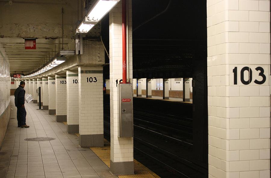 Waiting for the next train at the 103rd street subway station in New ...