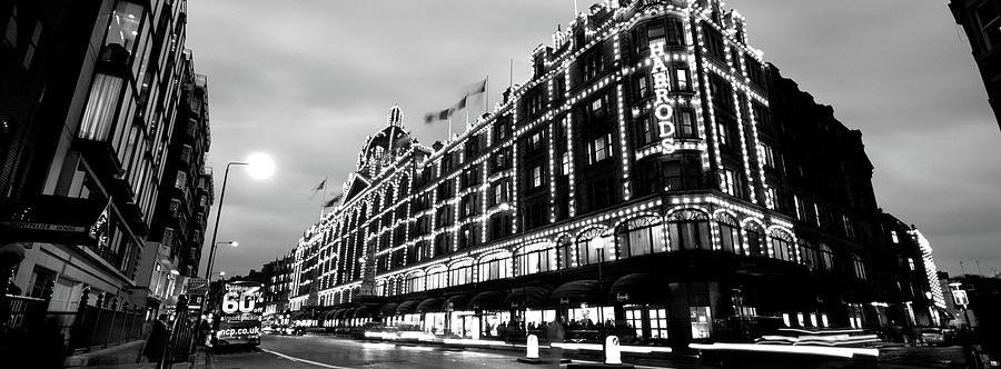 Black And White Photograph - Low Angle View Of Buildings Lit #11 by Panoramic Images