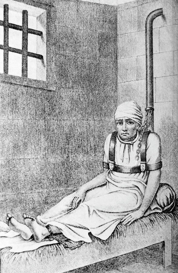 Mental Illness Photograph - 18th Century Female Patient Chained To A Post by Science Photo Library