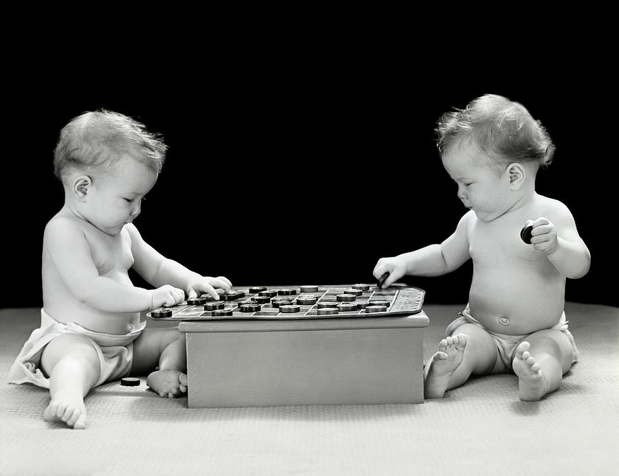 Black And White Photograph - 1930s 1940s Twin Babies Playing Game by Vintage Images