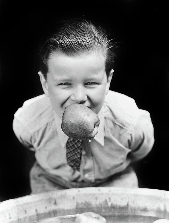 Black And White Photograph - 1930s Boy Bobbing For Apples With An by Vintage Images