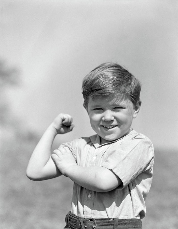 1930s Smiling Boy Making Strong Muscle Photograph by Vintage Images