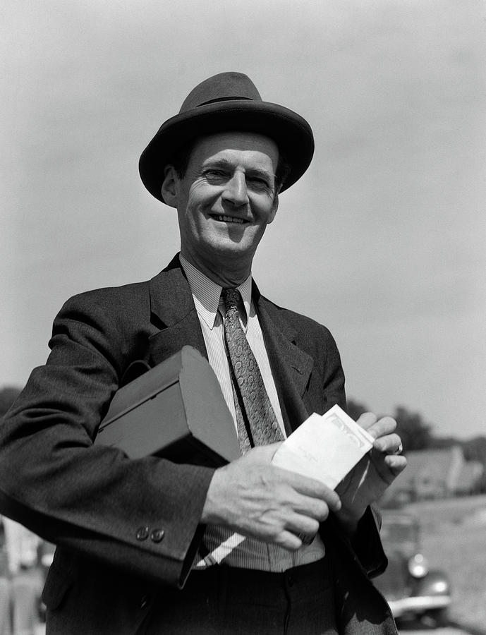 Black And White Photograph - 1930s Smiling Man In Hat Suit And Tie by Vintage Images