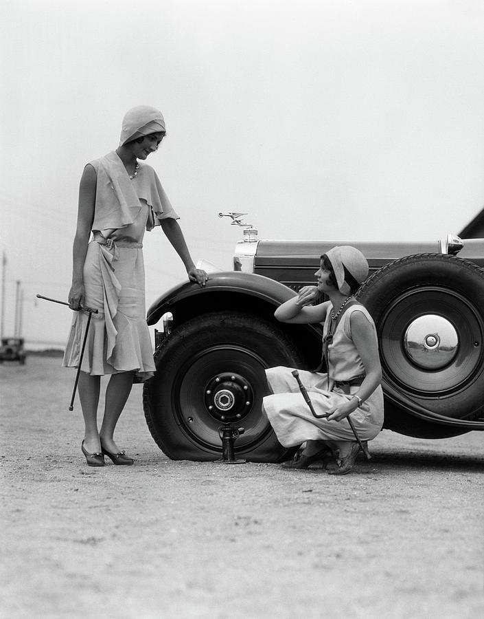 Black And White Photograph - 1930s Two Women Confront An Automobile by Vintage Images