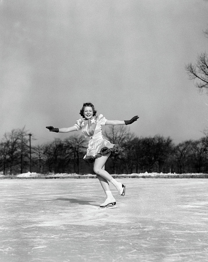 Black And White Photograph - 1940s Smiling Woman On Ice Outdoors Ice by Vintage Images