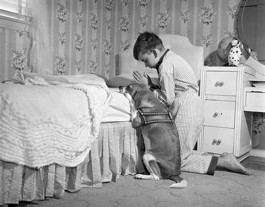 Black And White Photograph - 1950s Boy & Dog Praying At Bedside by Vintage Images