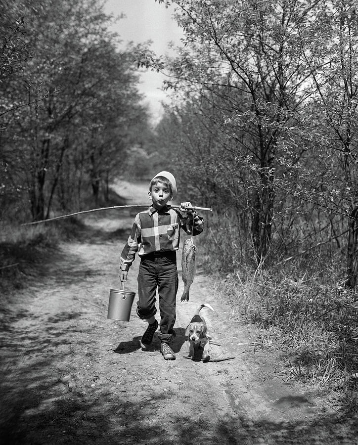 Black And White Photograph - 1950s Boy With Beagle Puppy Walking by Vintage Images