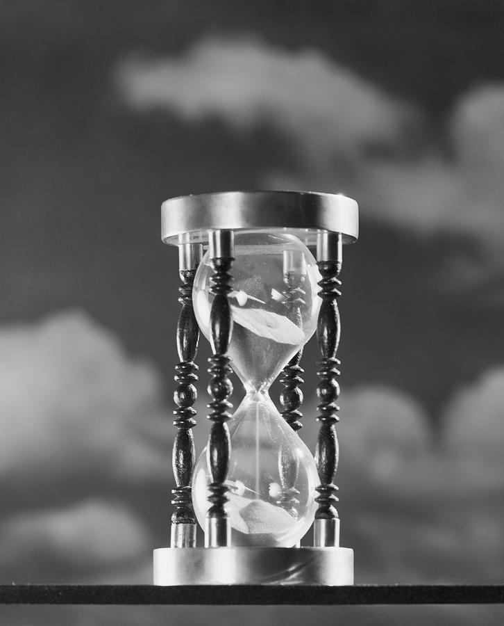 Black And White Photograph - 1950s Hourglass Against Background by Vintage Images