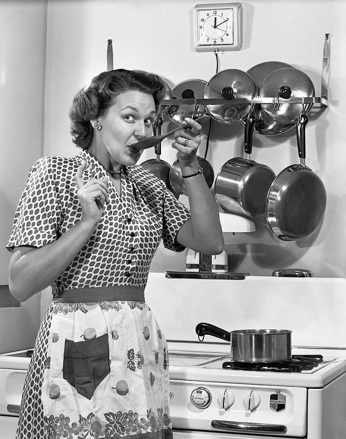 Black And White Photograph - 1950s Housewife Cooking Tasting Sauce by Vintage Images