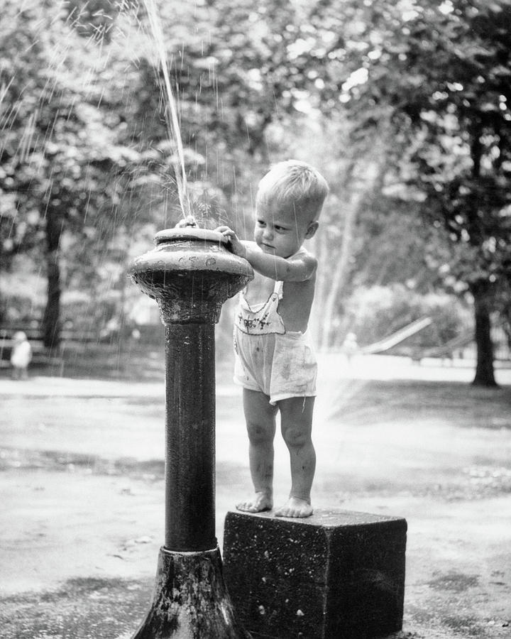 https://images.fineartamerica.com/images-medium-large-5/1950s-little-boy-playing-in-water-vintage-images.jpg