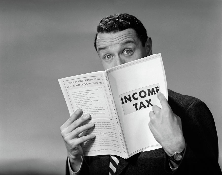 Black And White Photograph - 1950s Man In Suit Nose In Income Tax by Vintage Images