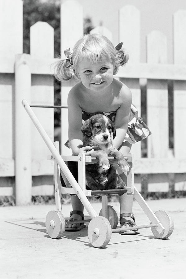 Black And White Photograph - 1950s Smiling Girl With Blonde Pigtails by Vintage Images