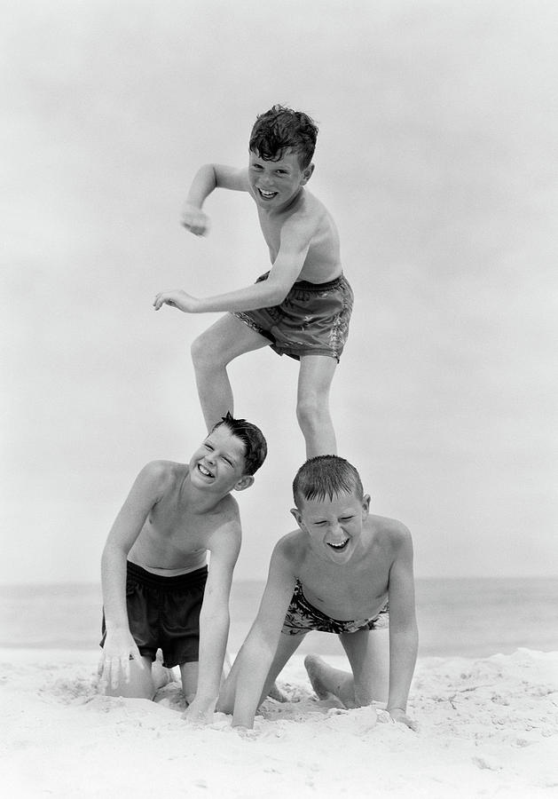 Black And White Photograph - 1950s Three Boys In Bathing Suits Form by Vintage Images