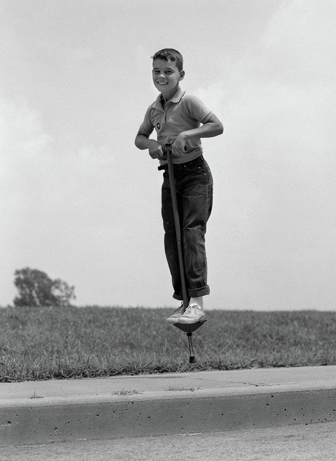 1960s Boy Jumping On Pogo Stick Photograph by Vintage Images Pixels