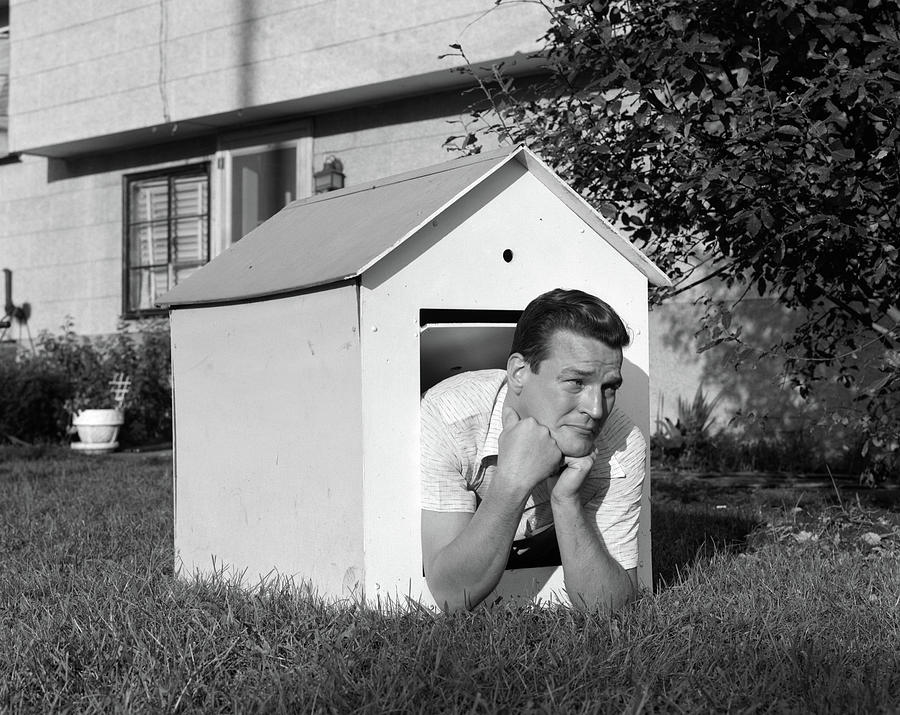 1960s-man-in-doghouse-in-backyard-vintage-images.jpg