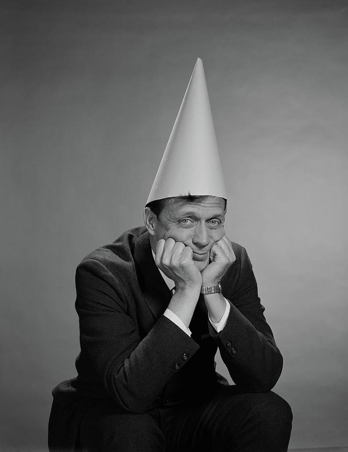 1960s-man-wearing-dunce-cap-vintage-imag