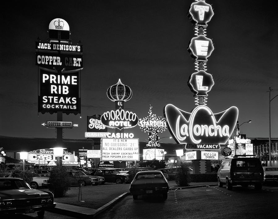 Black And White Photograph - 1980s Night Neon On The Strip For El by Vintage Images