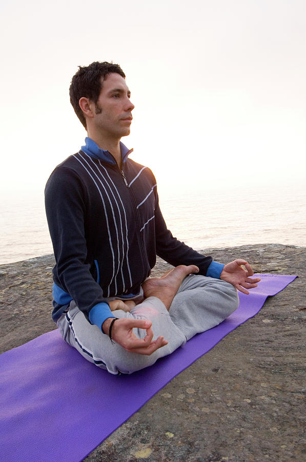 A Man Practicing Yoga On A Rocky Photograph by Lars Schneider - Fine ...