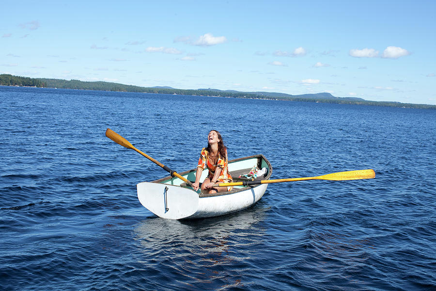 A Woman In A Small Rowboat On A Lake Photograph by Woods Wheatcroft