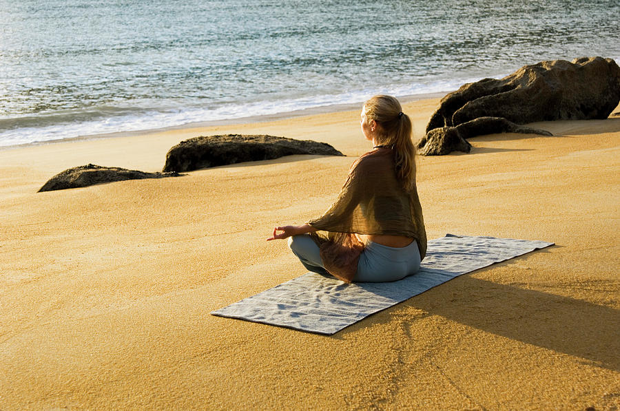 A Woman Practicing Yoga On A Beach Photograph By Lars Schneider