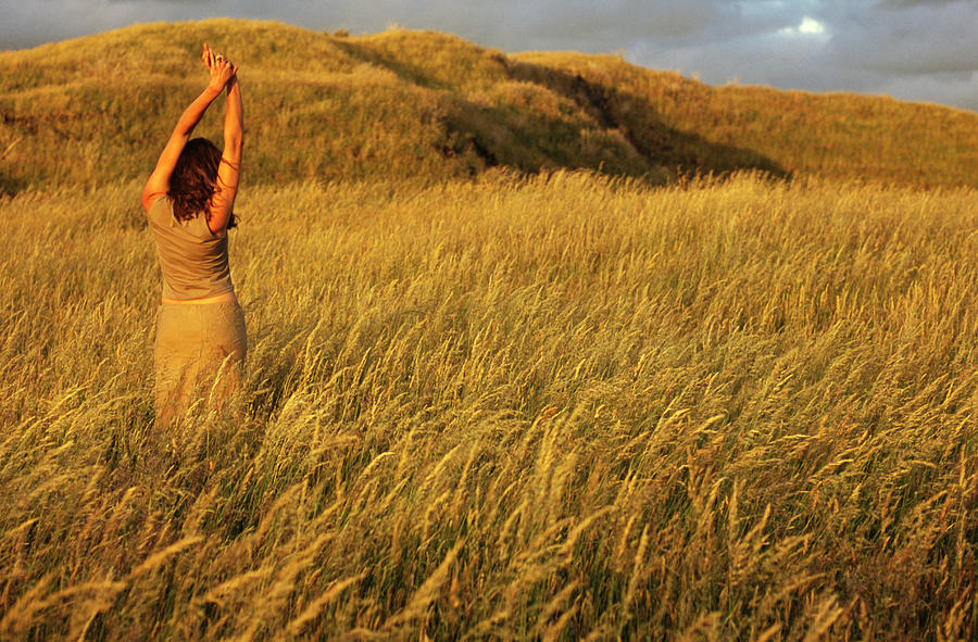 Sunset Photograph - A Young Woman Stretches In A Field #2 by Kyle George