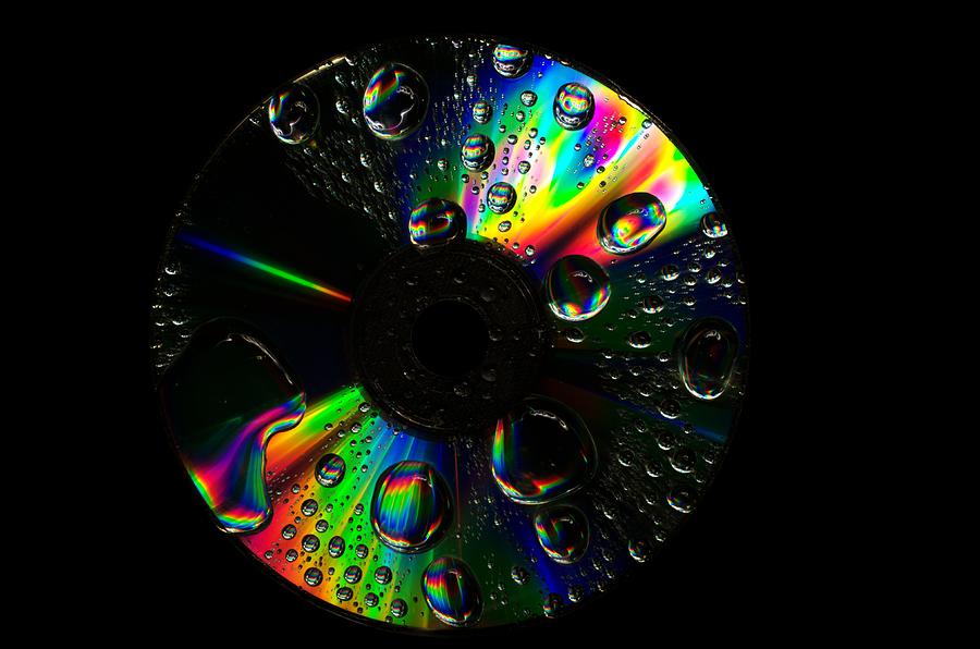 Abstract Photograph - Abstract rainbow droplets on cd #2 by Radu Nedelcu
