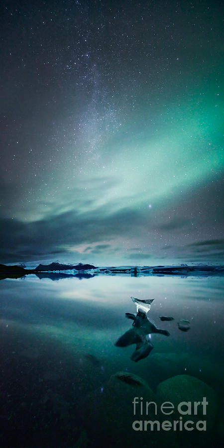 Nature Photograph - Aurora borealis Northern lights over glacial lagoon in Iceland #1 by Matteo Colombo