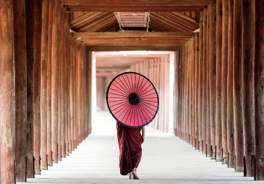Buddhist Monk Walking Along Temple Photograph by Martin Puddy
