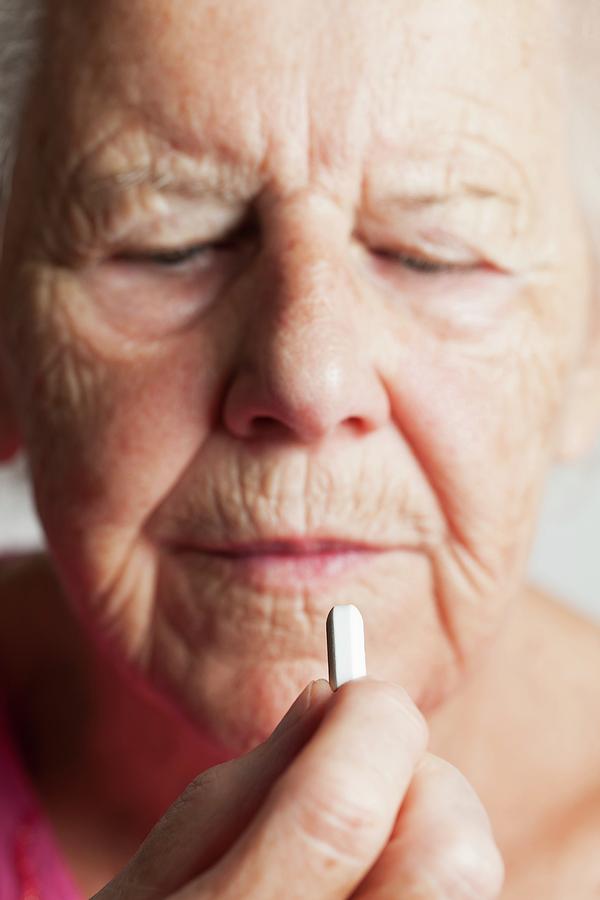 Elderly Woman Taking A Pill Photograph By Cristina Pedrazzini Science Photo Library