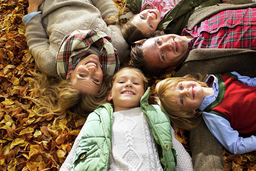 Fall Photograph - Family Lying Down On Autumn Leaves #2 by Science Photo Library
