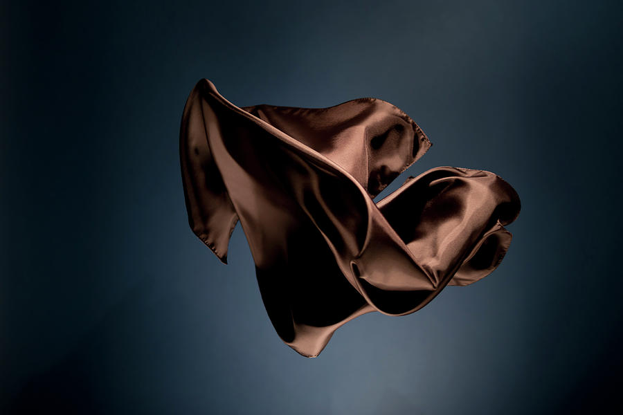 Floating Brown Satin On A Dark Blue #2 Photograph by Gm Stock Films