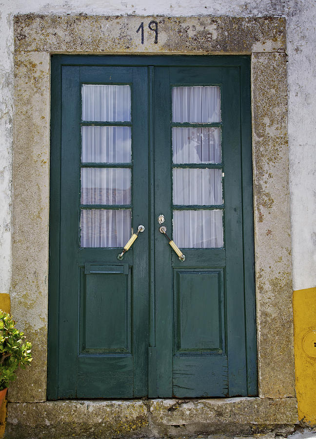 Green Wood Door With Hand Carved Stone Against A Texured Wall In The Medieval Village Of Obidos Photograph