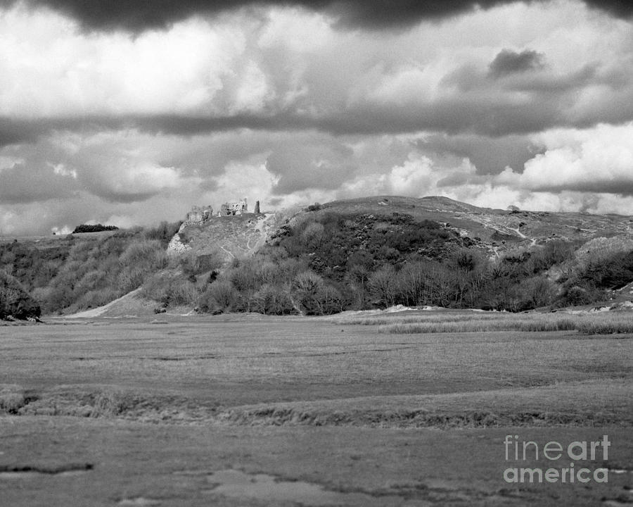 Louring clouds over Pennard Castle Photograph by Paul Cowan