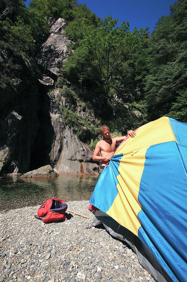 Man Erecting A Tent By A River #2 Photograph by Mauro Fermariello/science Photo Library