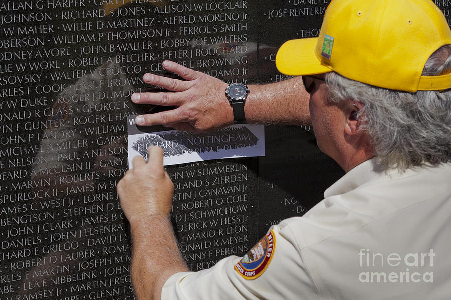 Man Getting A Rubbing Of Fallen Soldiers Name At The Vietnam War