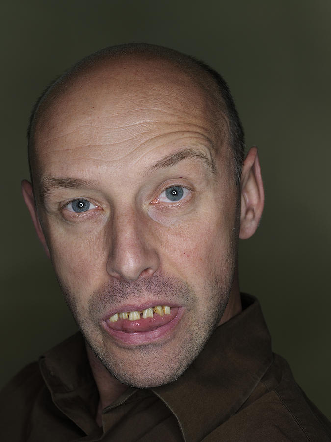 Mature man wearing fake teeth, making funny face, close-up, portrait #2 Photograph by Christian Adams