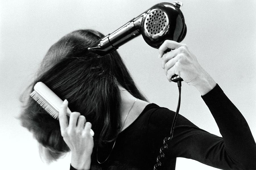 Model Blow Drying Hair Photograph by Mike Reinhardt
