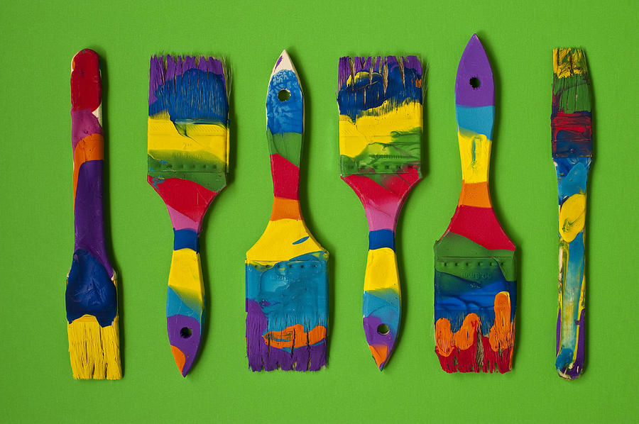 Multicolored paint brushes on green background #3 Photograph by Jim Corwin