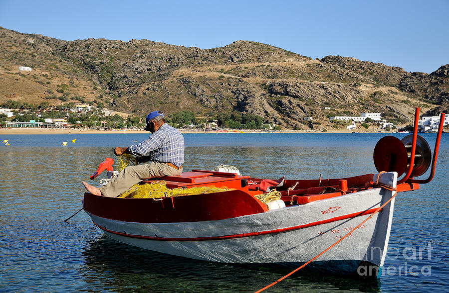 Fisherman in Mylopotas beach Photograph by George Atsametakis