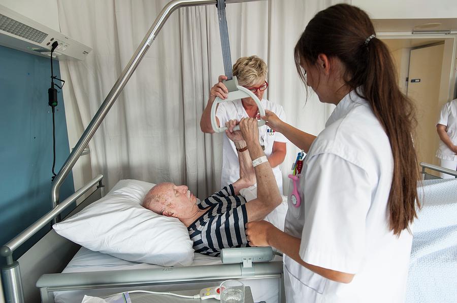 Nurses Assisting Patient Photograph By Arno Massee Science Photo 