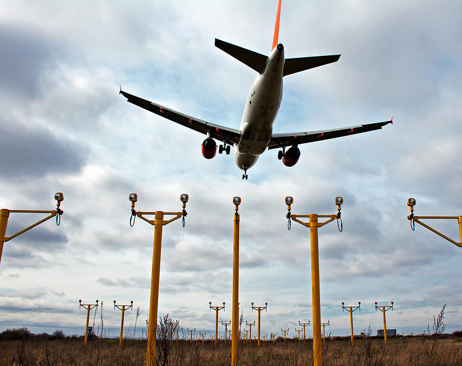 Passenger plane on final approach with landing lights in view ...